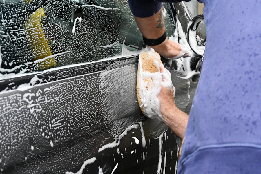 Hand washing a car with sponge