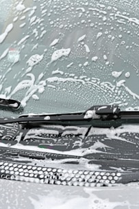 Image showcasing the spray being used on a frosted windshield.