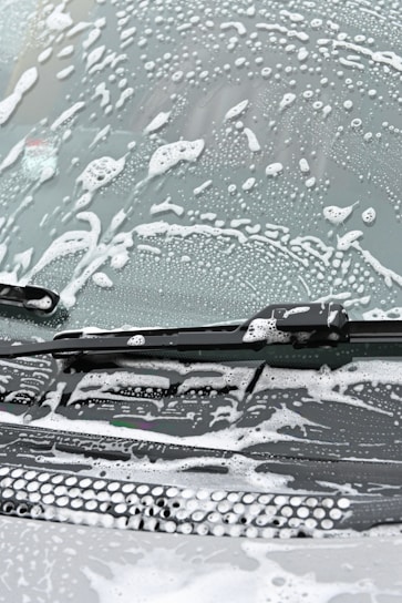 Close-up of a car windshield with ExoShield protective film being applied smoothly.