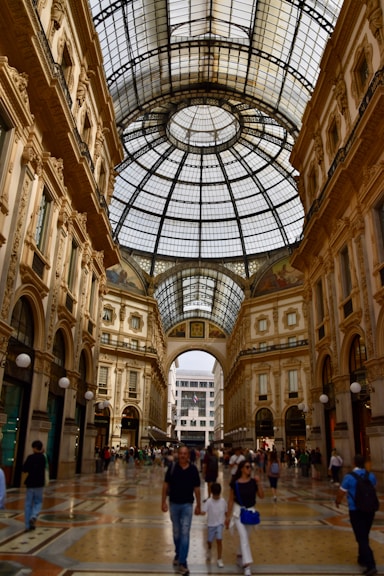 a group of people walking through a large building