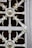 An intricate wrought iron grate featuring symmetrical designs with circular and floral motifs. The metalwork includes elegant curves and decorative elements, combining function with artistic expression.
