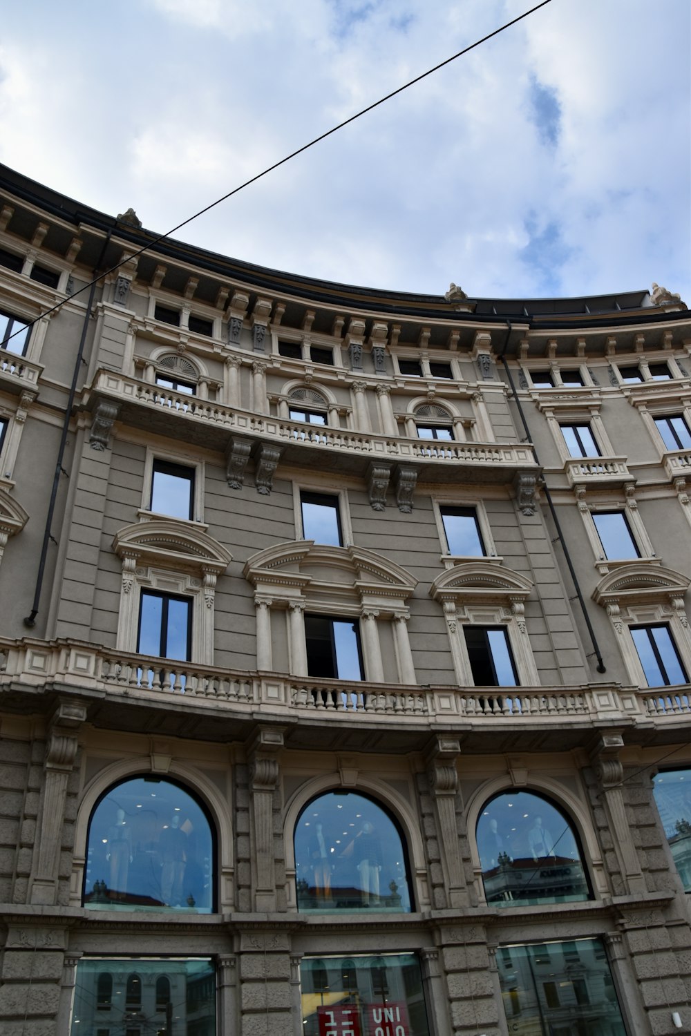 a large building with many windows and a sky background