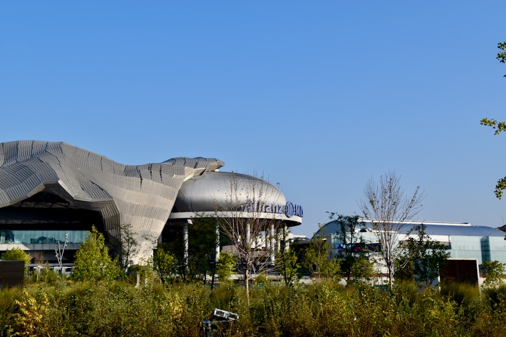 a large building with a giant metal object on top of it