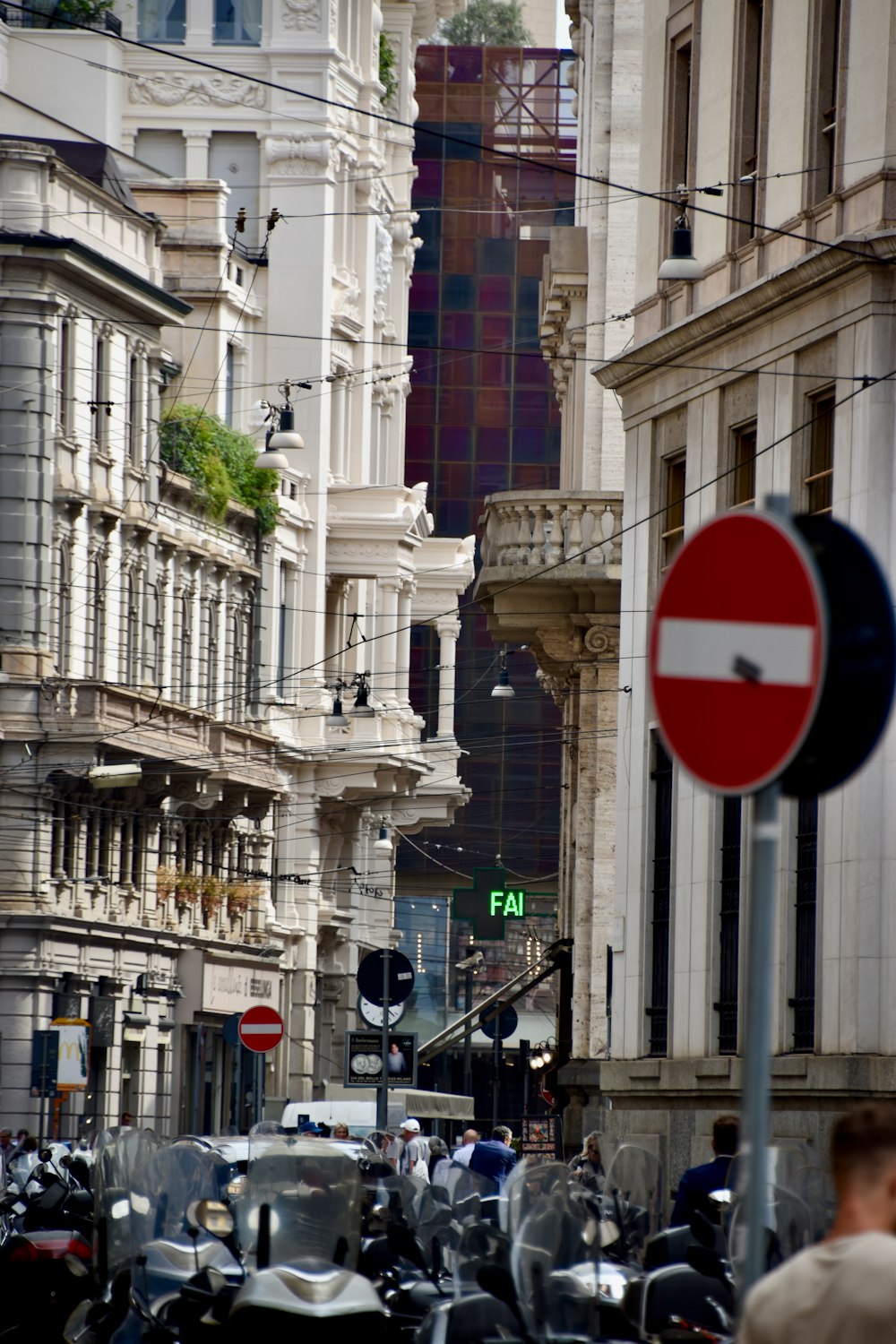 a street filled with lots of traffic next to tall buildings