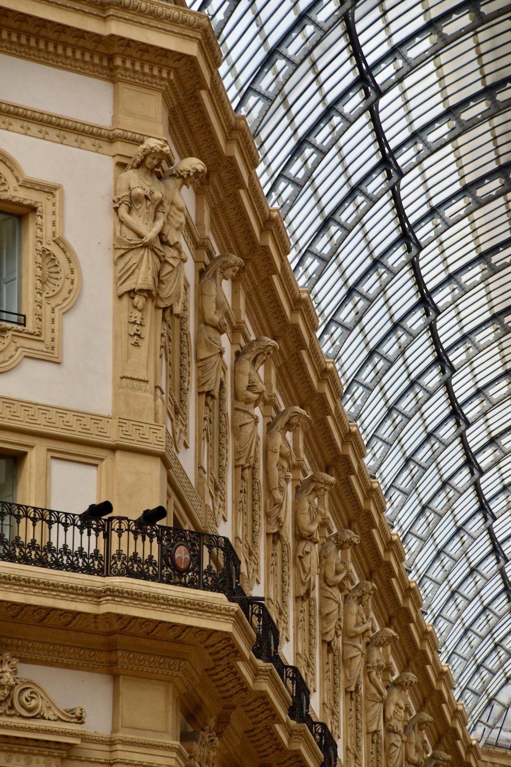 a building with a glass roof and a balcony