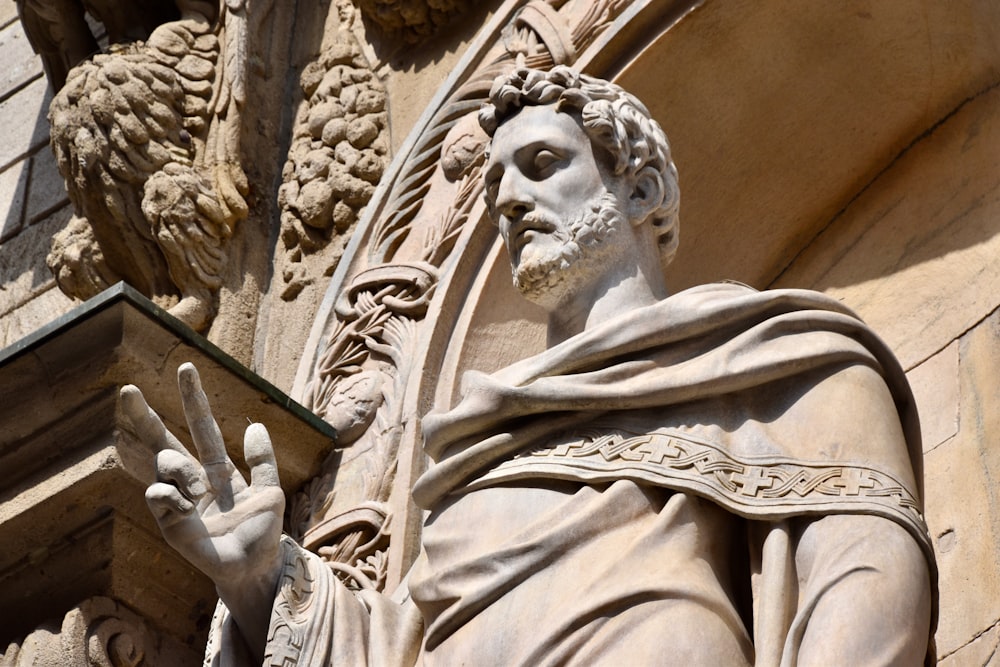 a close up of a statue of a man holding a book