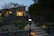 A sleek, modern villa exterior at dusk showcasing elegant architectural lighting.