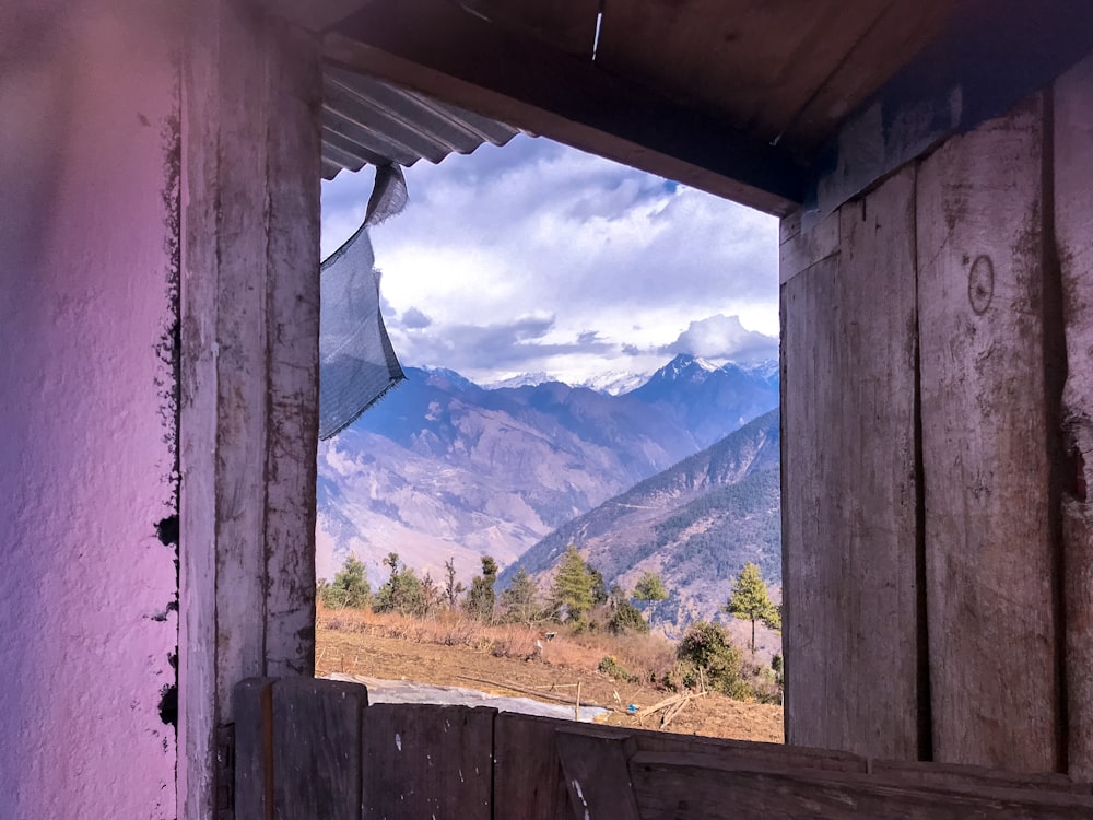 a window with a view of a mountain range