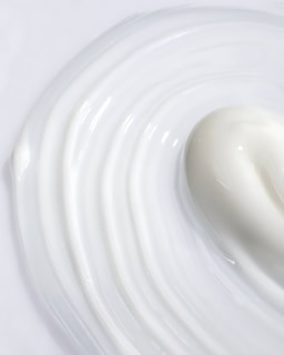 A creamy milk paleta melting slightly, showing its smooth texture and natural color.