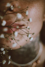 Close-up portrait of Nany Palacio Love with soft pink background.