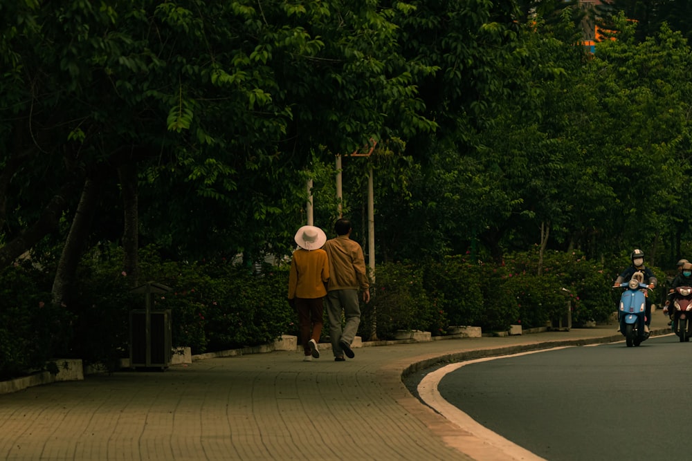 a group of people riding motorcycles down a street