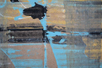 An abstract composition with bold splashes of blue and gold blending dynamically