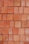 Neatly stacked red bricks ready for construction projects.