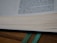 A close-up photo of an elegant handmade bookmark resting inside an open book.
