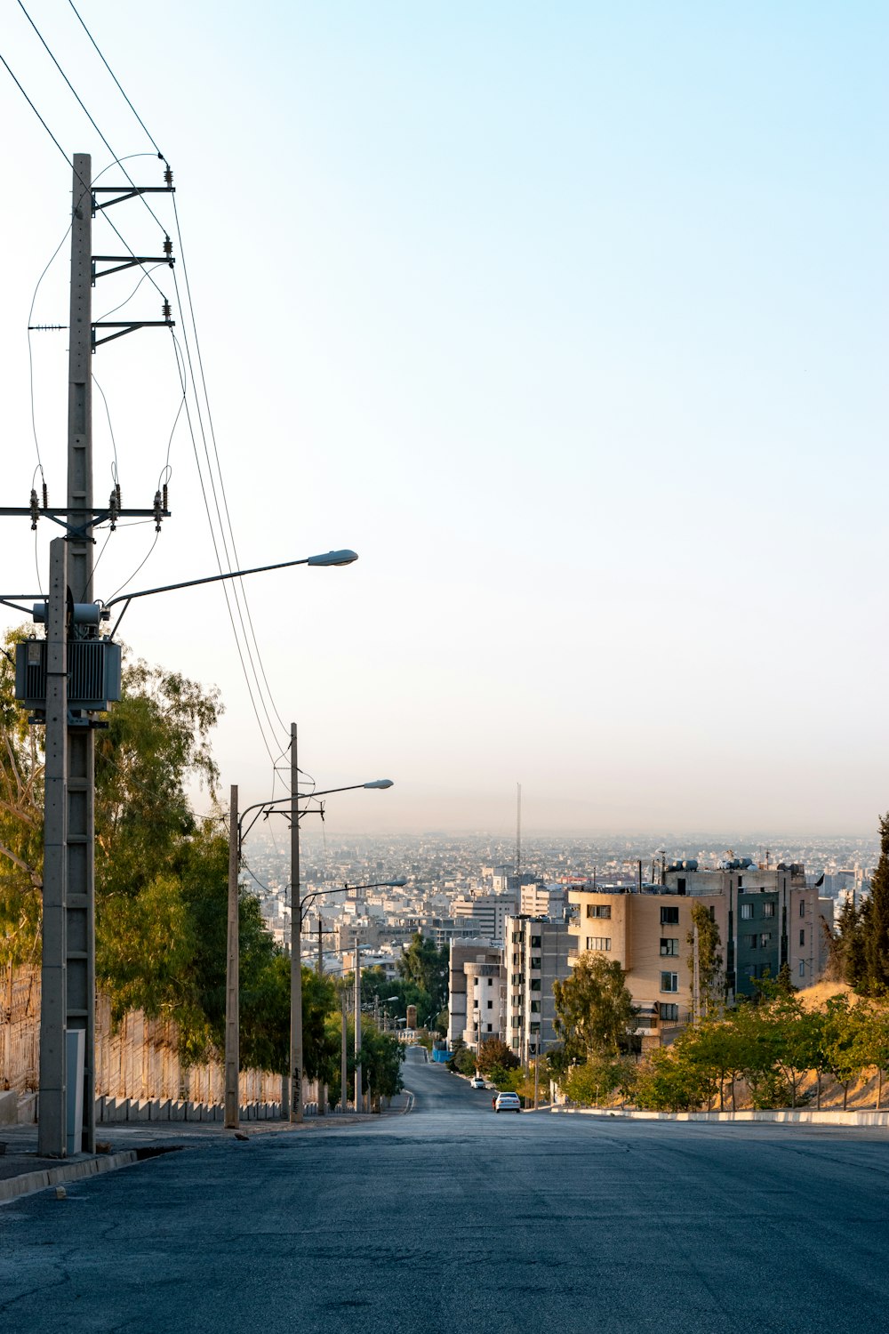 an empty street with power lines above it