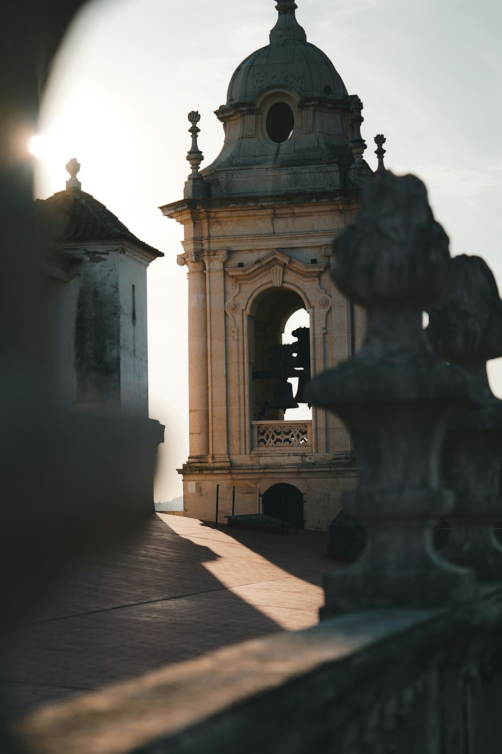 a clock tower with a bell on top of it