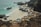 a group of boats sitting on top of a beach next to the ocean