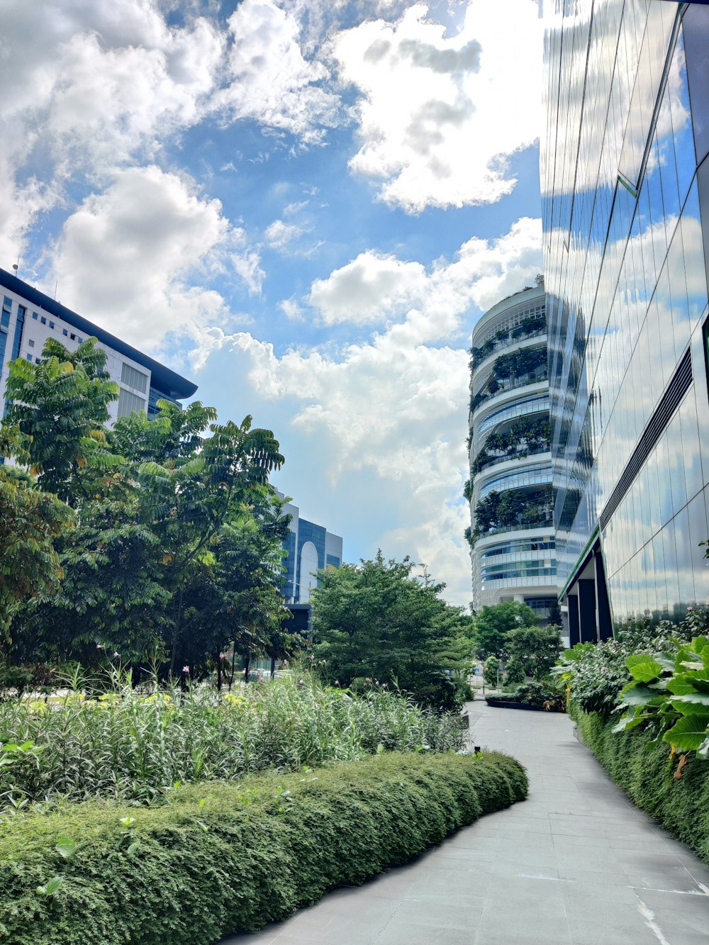 a very tall building sitting next to a lush green park