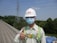 A happy customer giving a thumbs up in front of a completed construction project.