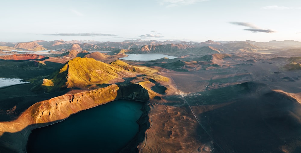 an aerial view of a lake surrounded by mountains