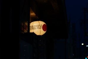 Traditional Japanese paper lanterns glowing softly at dusk.