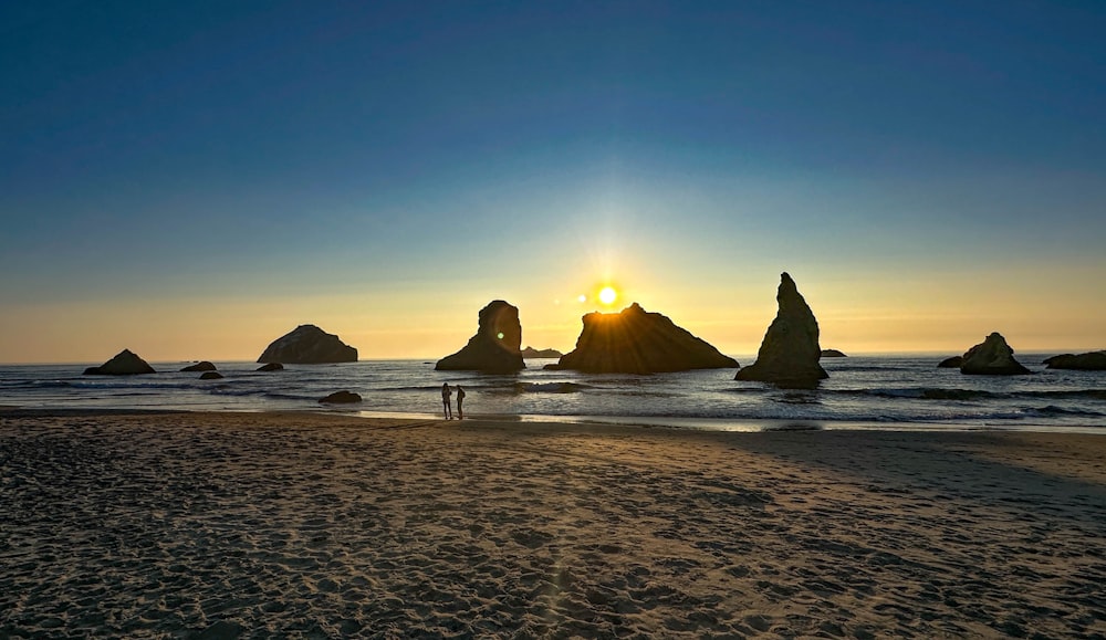 a person standing on a beach next to the ocean