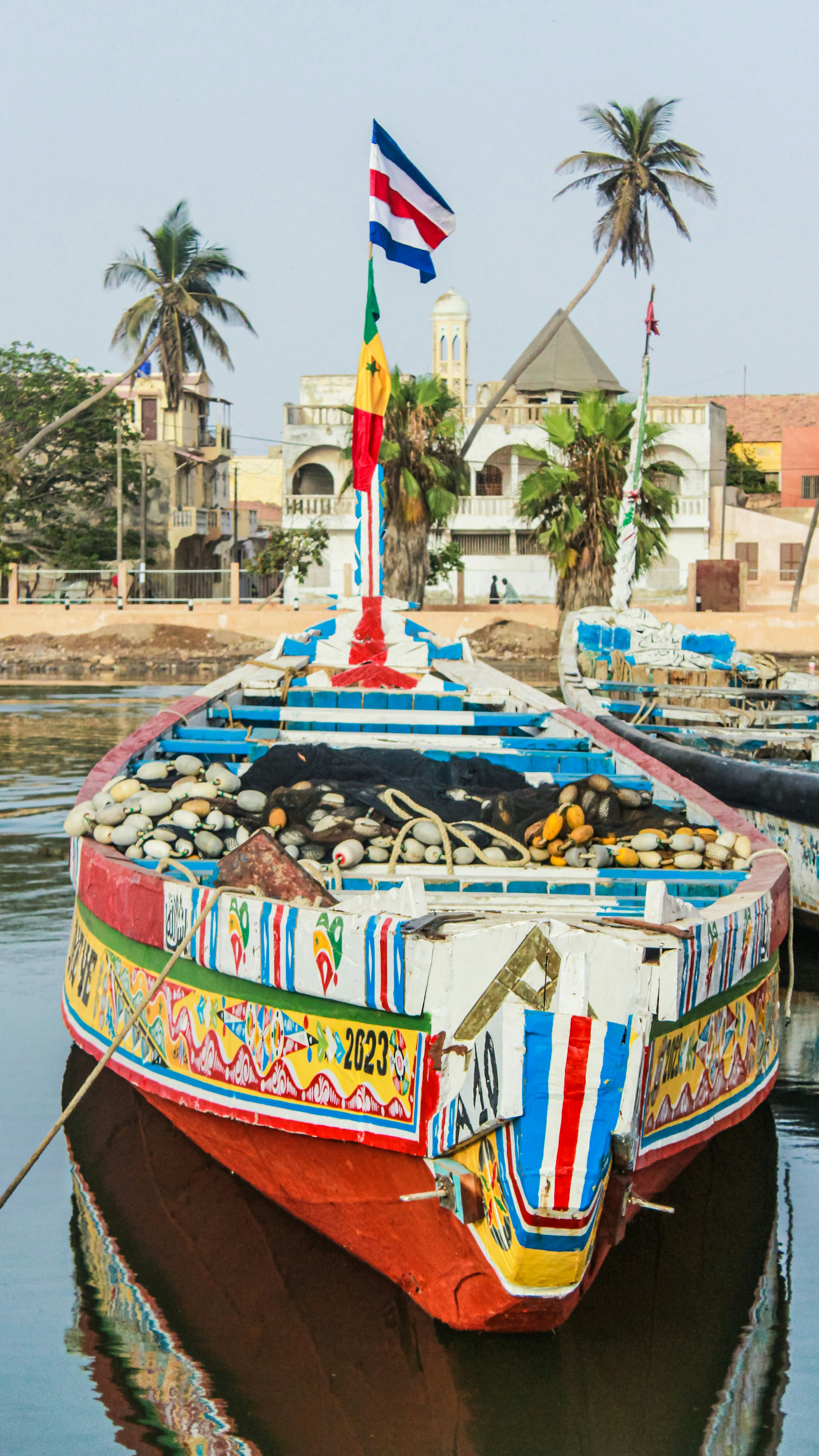 a colorful boat is docked in the water