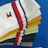 A collection of colorful socks neatly stacked on top of a blue surface. The socks display a variety of colors including white, yellow, green, black, and gray, each featuring a red and navy blue striped pattern. One sock has a small embroidered logo.