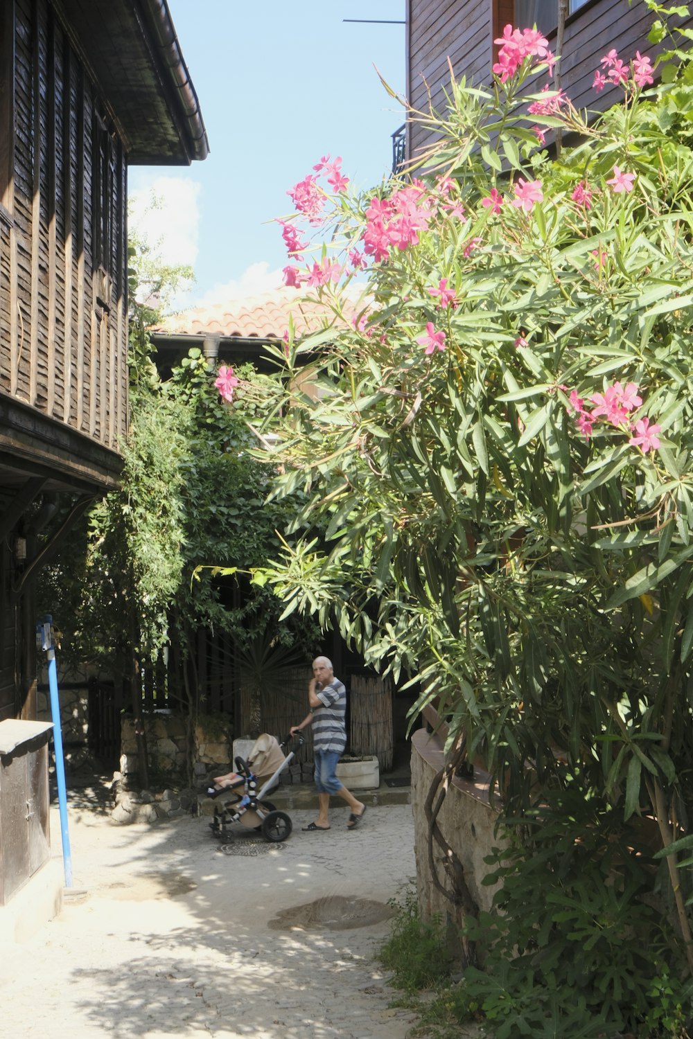 a man walking down a street next to a building