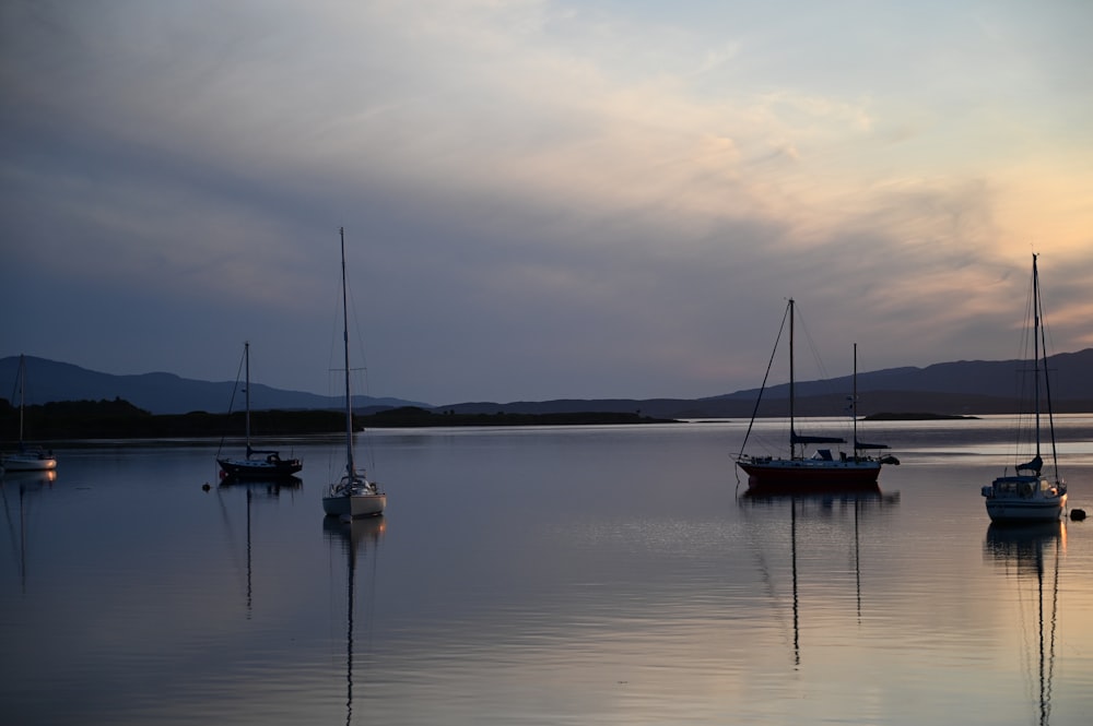 a group of boats floating on top of a lake