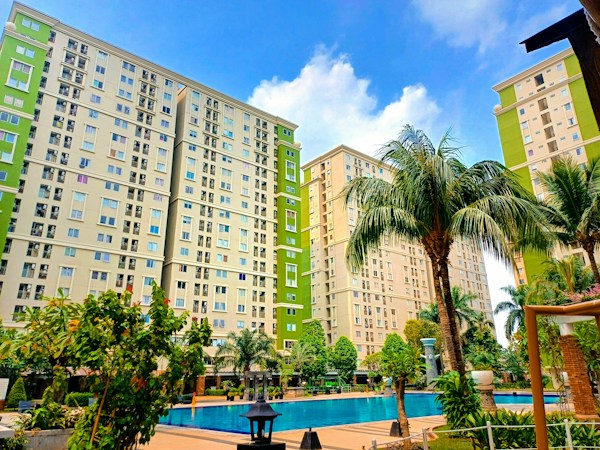 Multi-story apartment building with a resort-style pool and palm trees, the kind of newer rental competition Las Vegas landlords now face