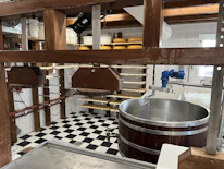 Artisan making fresh paneer in a traditional kitchen setting.
