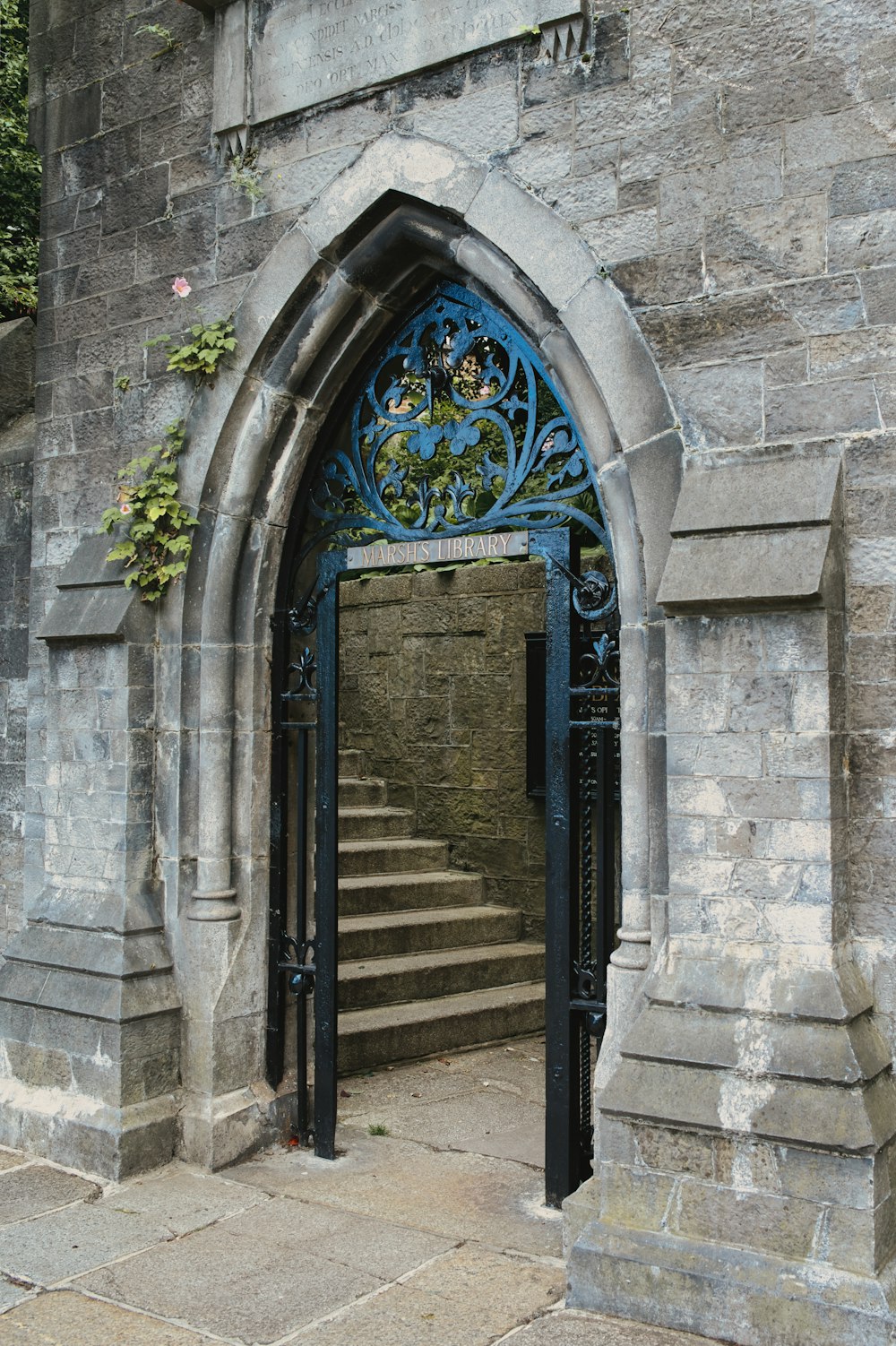 a stone building with a blue iron door