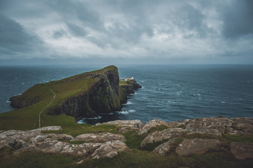 a large rock outcropping in the middle of a body of water