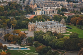 A stunning view of a traditional palace surrounded by lush greenery and mountains.