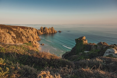 a view of the ocean from the top of a hill