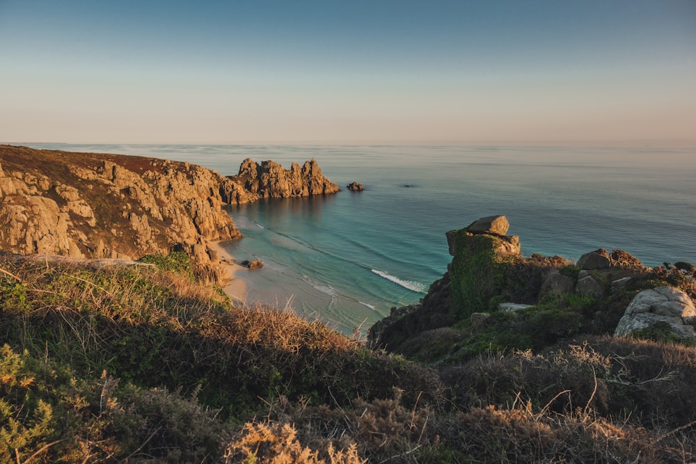 a view of the ocean from the top of a hill