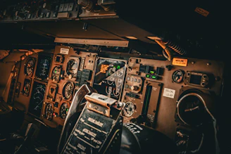 the cockpit of an airplane with many controls