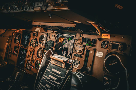 the cockpit of an airplane with many controls