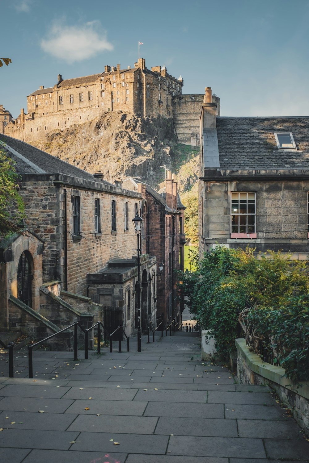 a narrow street with a castle in the background