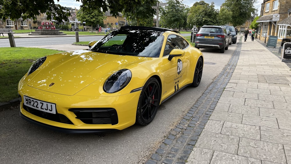 a yellow sports car parked on the side of the road