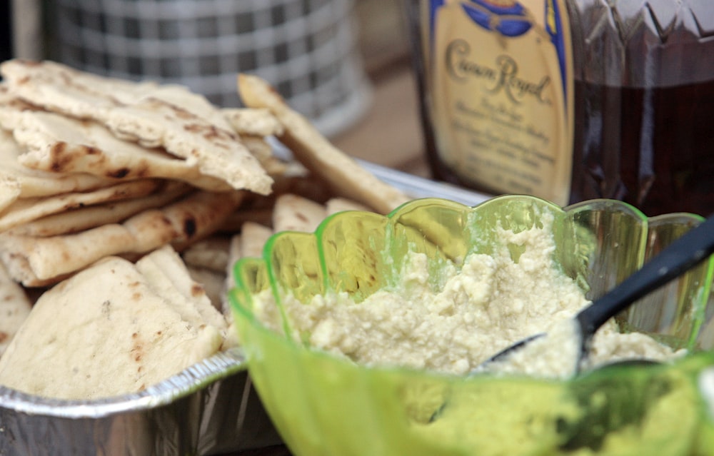 a plate of pita bread next to a bowl of pita bread