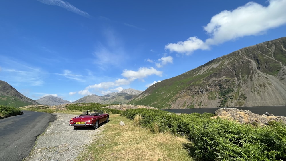 a red car parked on the side of a road