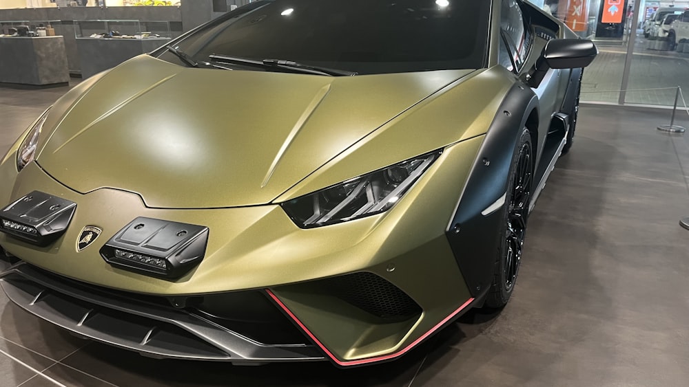 a gold colored sports car parked in a showroom