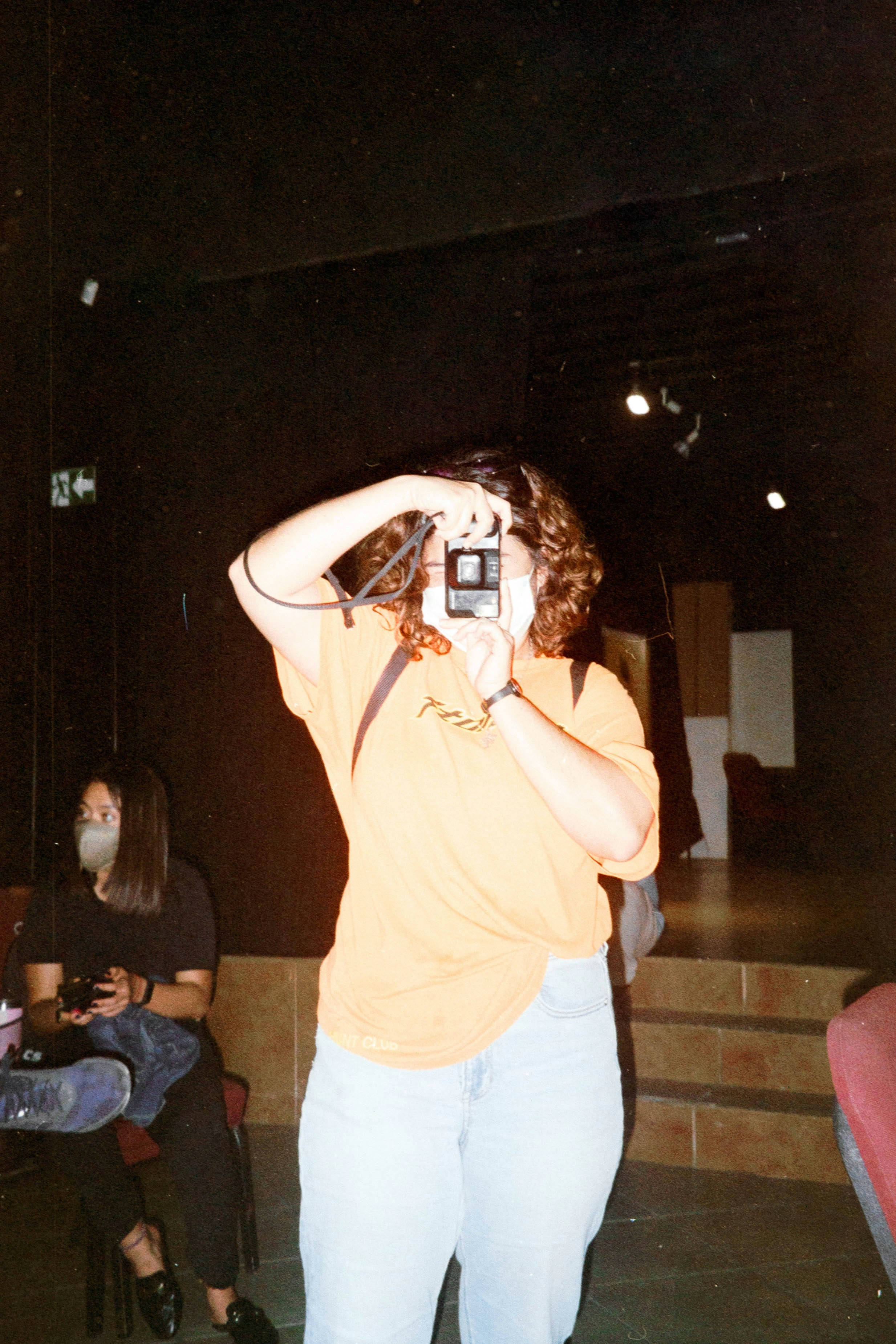 a woman taking a picture with a camera