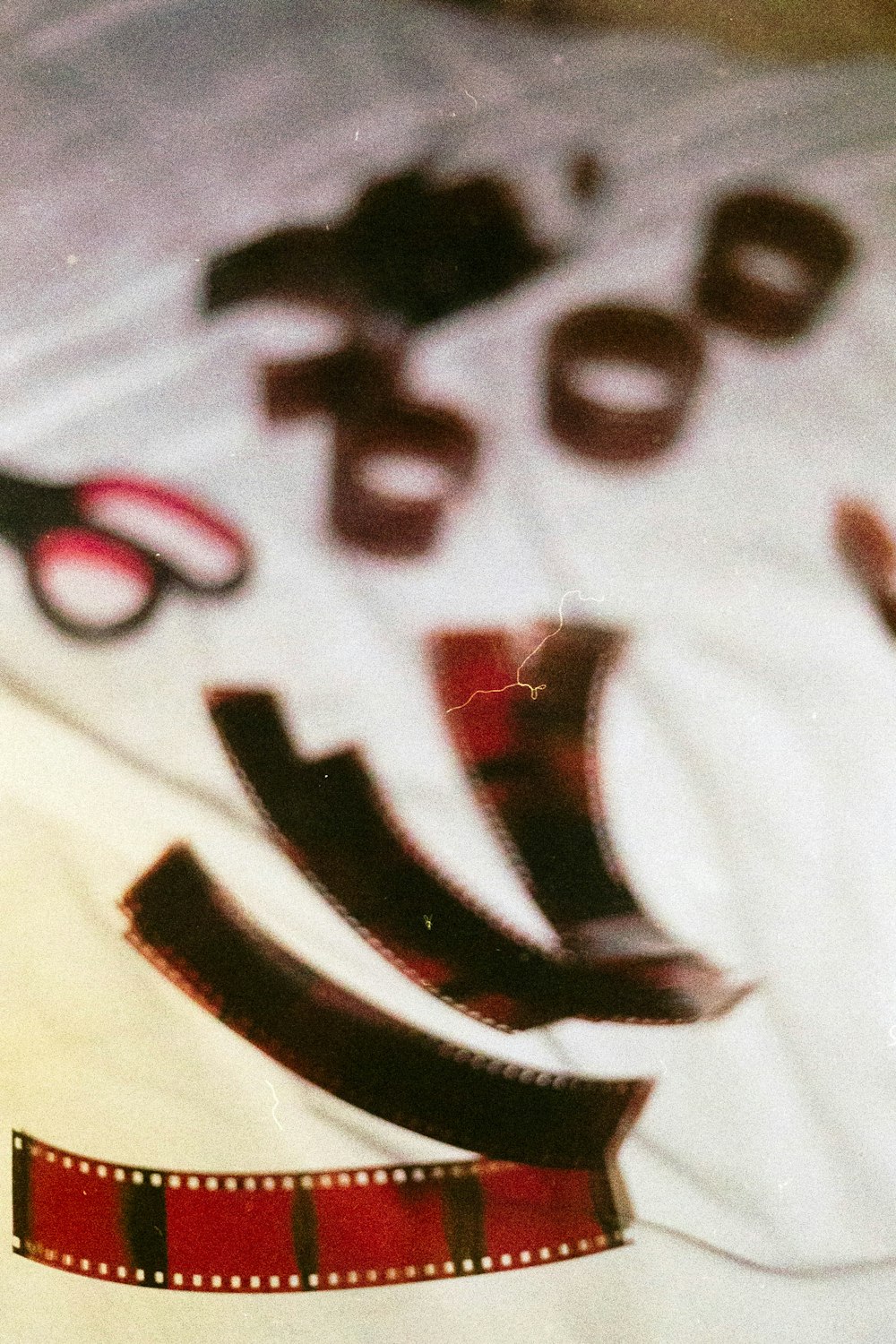 a pair of scissors sitting on top of a white sheet