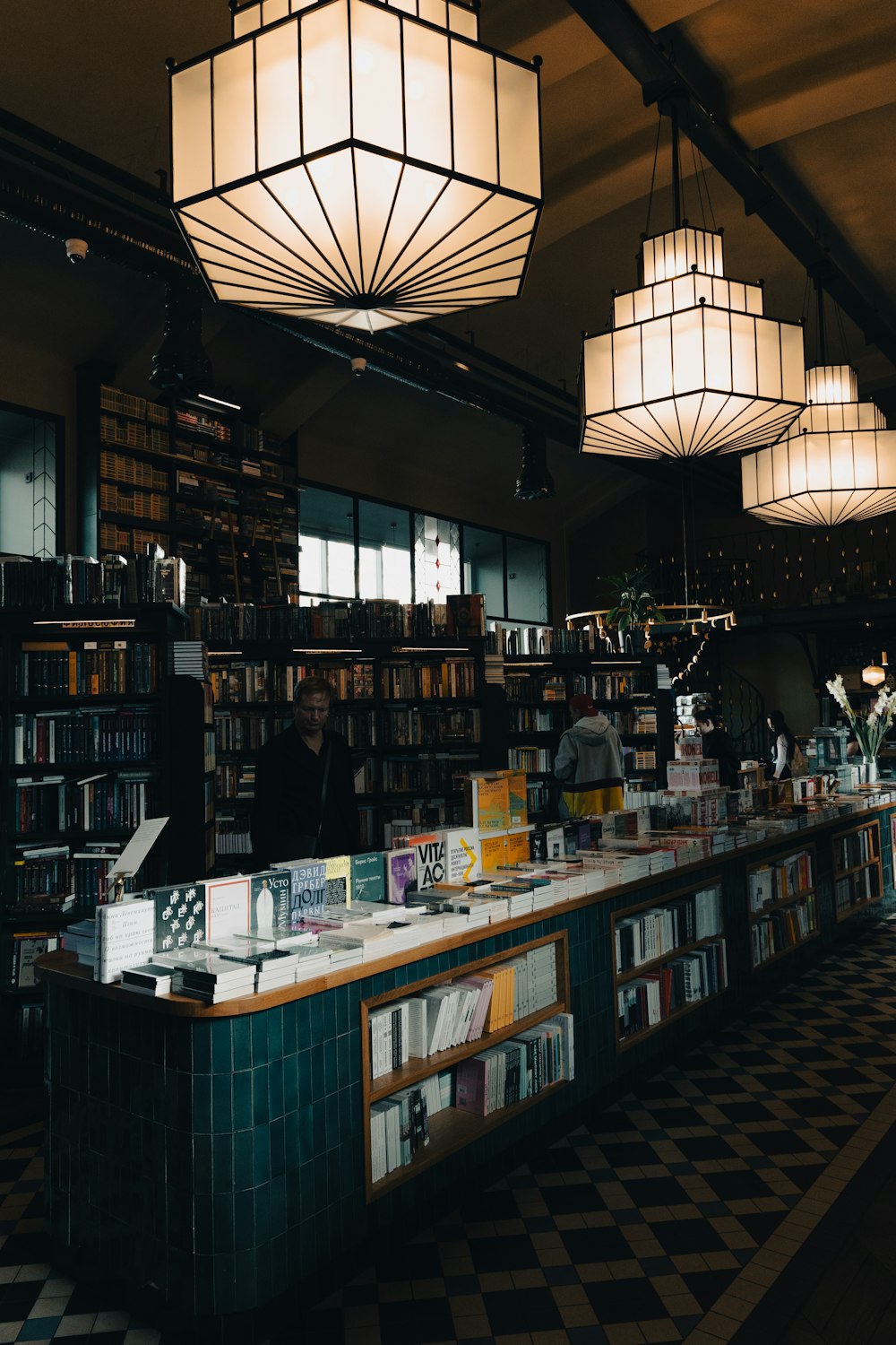 a man standing behind a counter in a library