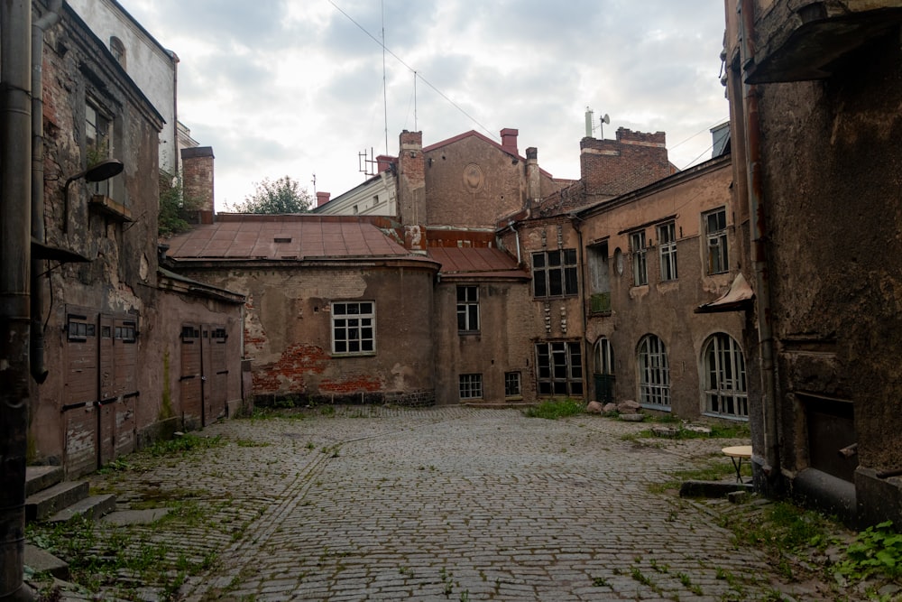 an old building with a cobblestone street in front of it
