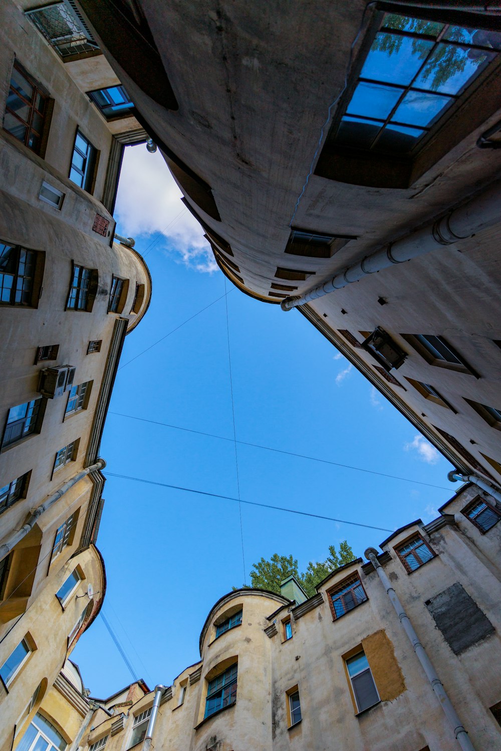 looking up at the sky from between two buildings