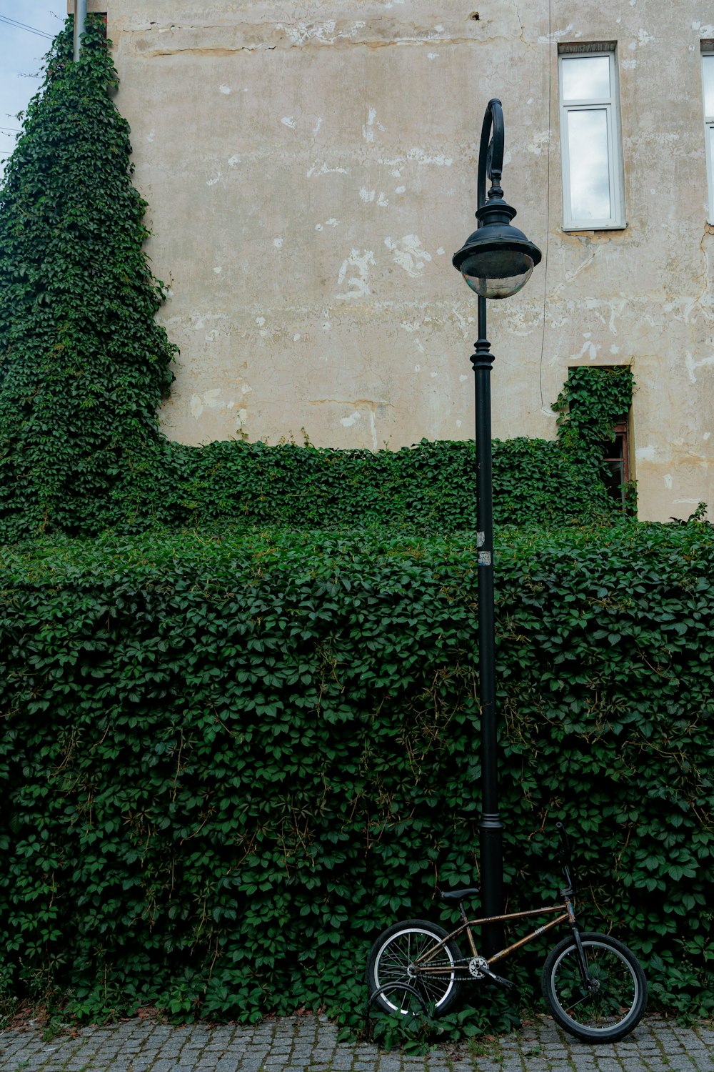 a bicycle parked next to a lamp post